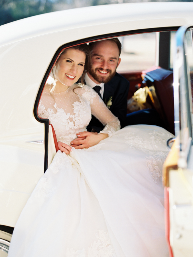 bride and groom in getaway car at winter wedding 