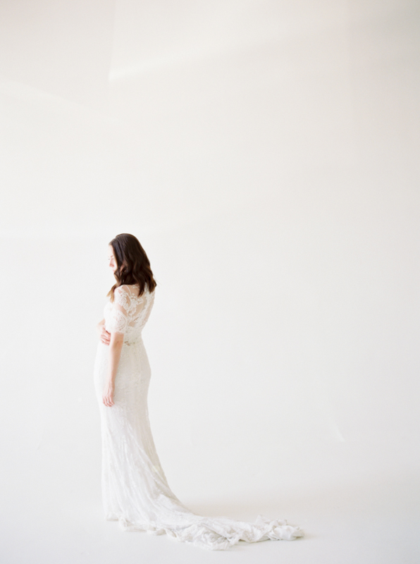 Elegant, Simplistic Bridal Look with Sleeved, Beaded Wedding Gown in a light-filled, cream background space outside of Nashville, TN