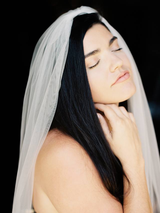 Romantic, Dramatic Bridal Portrait on dark background with long flowing veil 