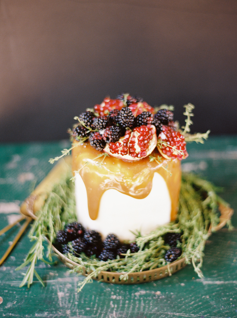 small wedding cake with caramel and berries and fruit decor