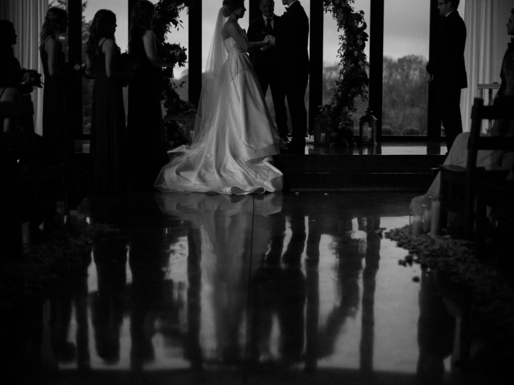 timeless black and white image of bride & groom at ceremony at gravestone quarry wedding venue Nashville, TN