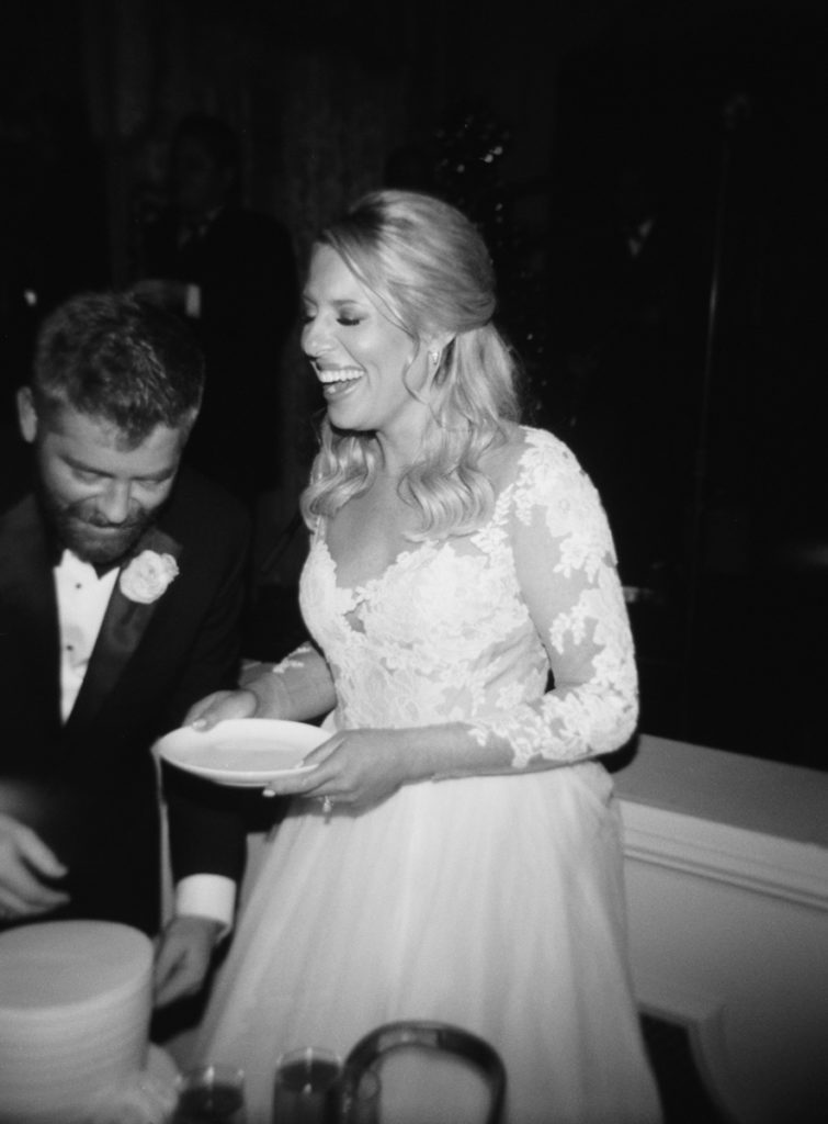 classic wedding film photographer in nashville, tn captures cutting the cake at wedding 