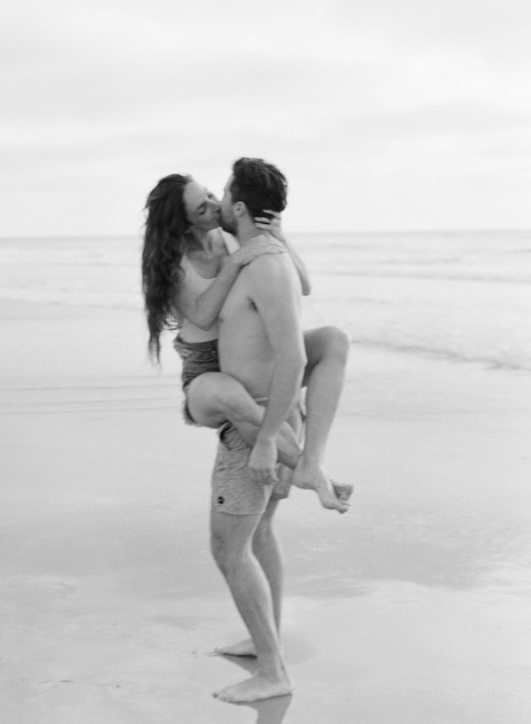 romantic, in the moment black and white image of newly engaged couple 