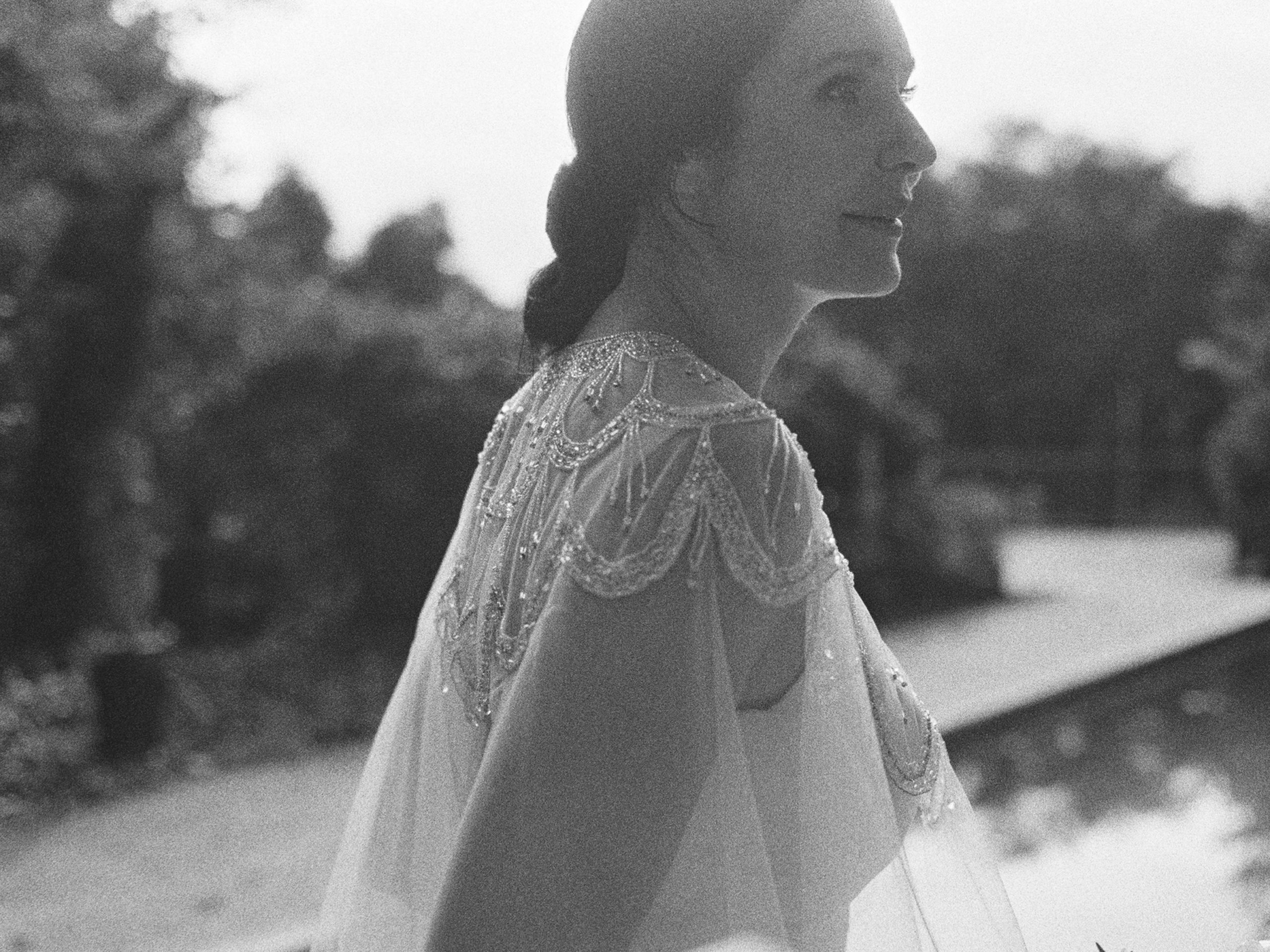 black and white film image of modern bride with cape veil at meadowlark 1939 wedding venue in atlanta georgia