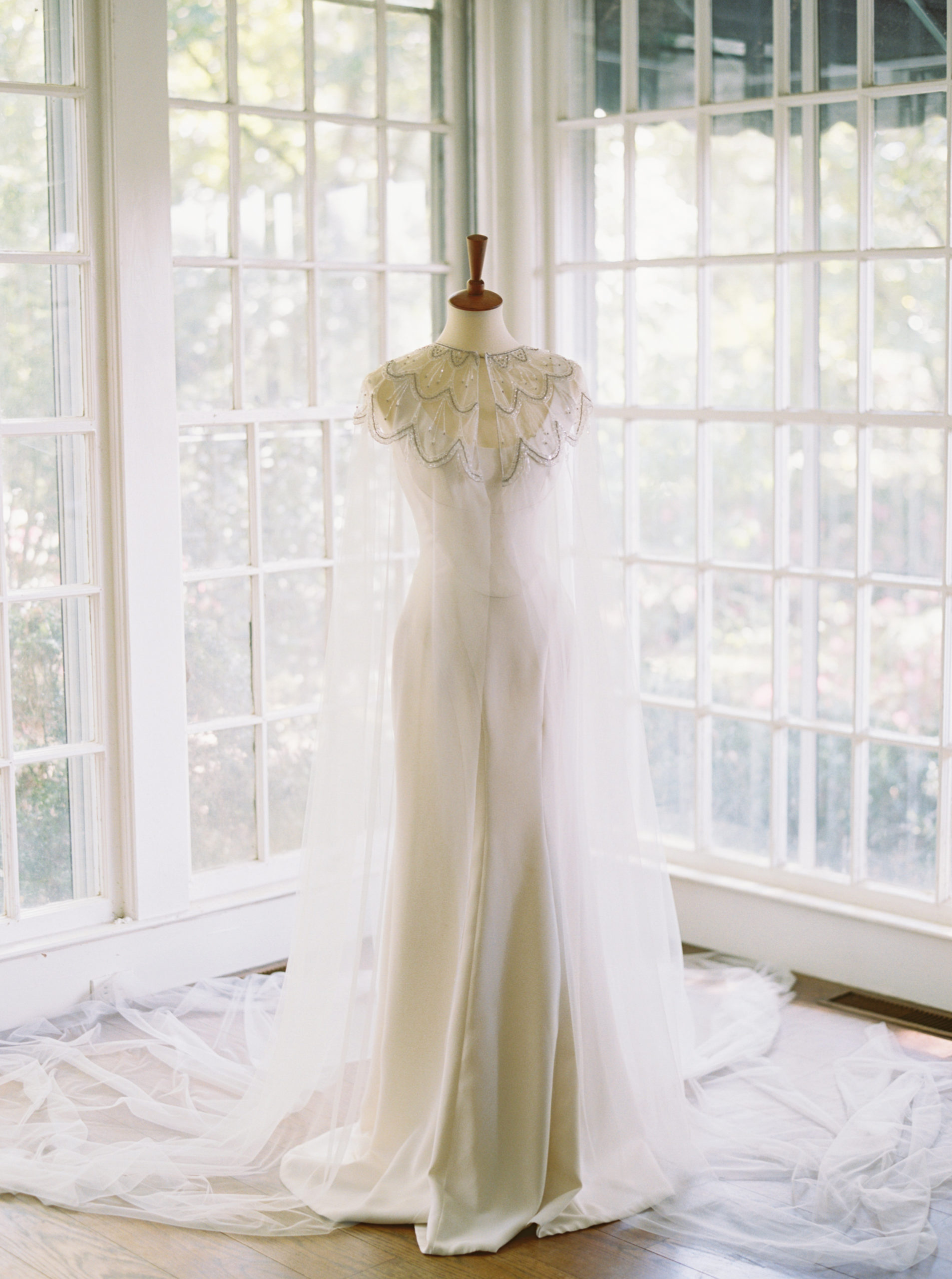 modern timeless wedding gown with veil cape at Meadowlark 1939 intimate wedding venue in Atlanta, Georgia shot by film wedding photographer Abigail Lewis Photography 